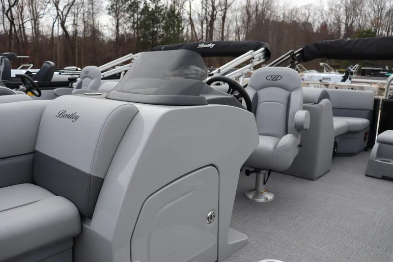 Slide: The Image of 2026 Bentley Pontoons Legacy 223 Navigator interior with sleek gray seating and modern dashboard. - 4