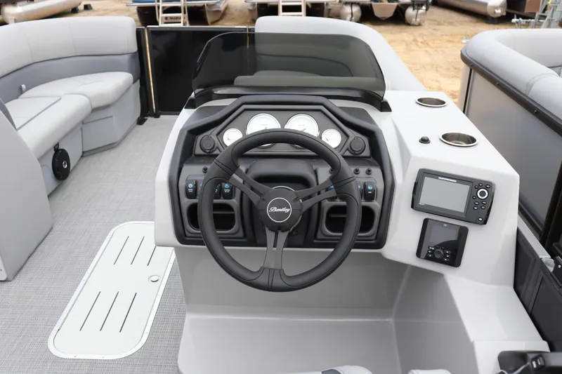 Slide: The Image of 2026 Bentley Pontoons Legacy 223 Navigator helm with steering wheel and control panel. - 5