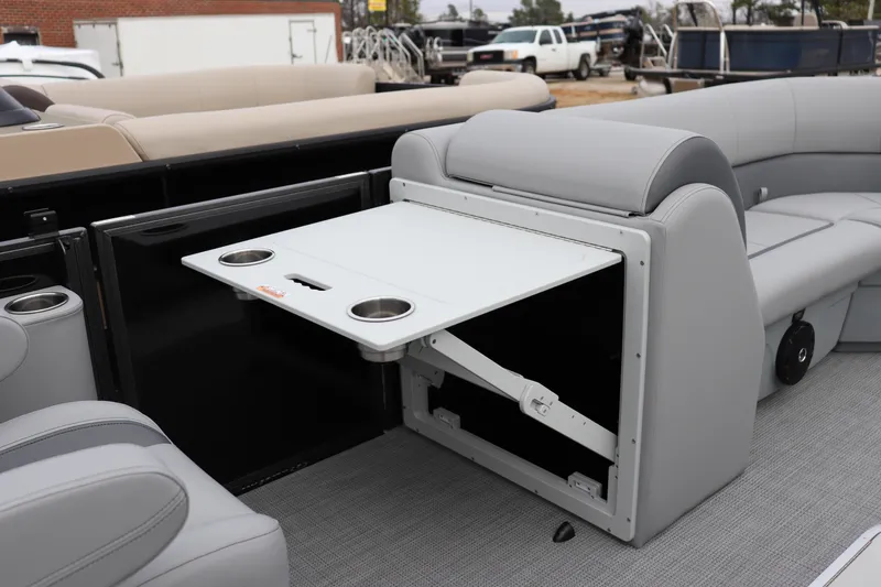 Slide: The Image of 2026 Bentley Pontoons Legacy 223 Navigator interior with foldable table and cup holders. - 7
