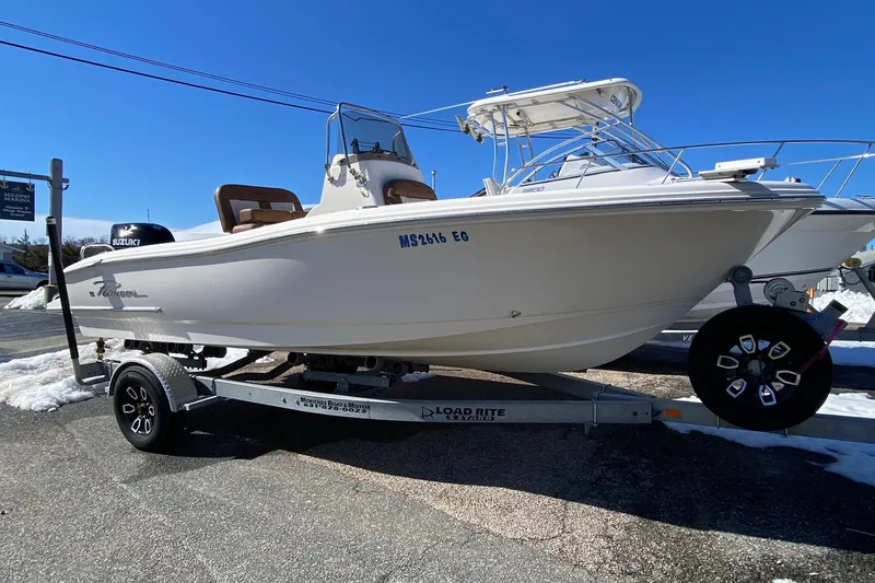 The Image of 2022 Pioneer 202 Sportfish boat on trailer under clear blue sky. - 0