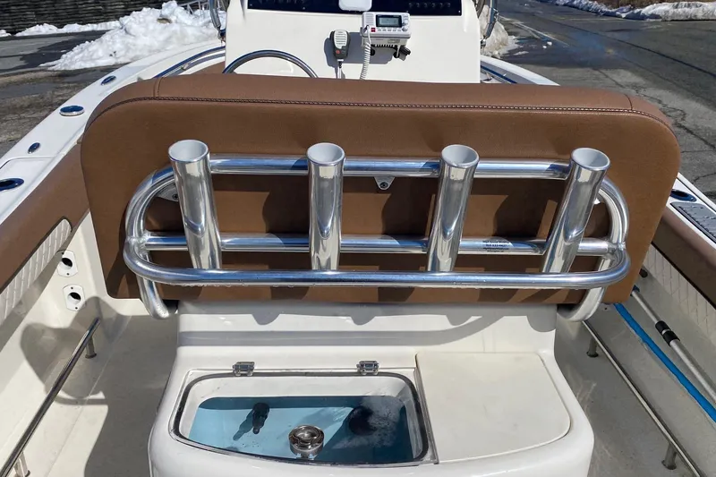 Slide: The Image of 2022 Pioneer 202 Sportfish boat interior with rod holders and livewell. - 10