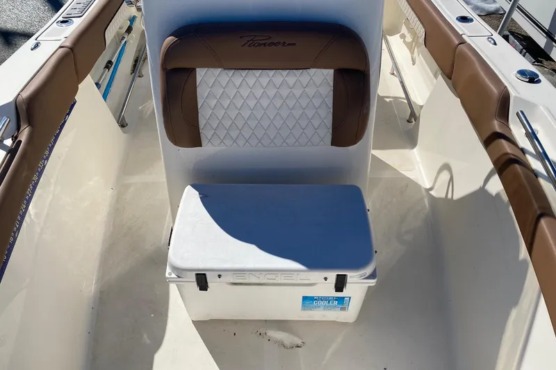 Slide: The Image of 2022 Pioneer 202 Sportfish boat interior with brown seating and Engel cooler. - 13