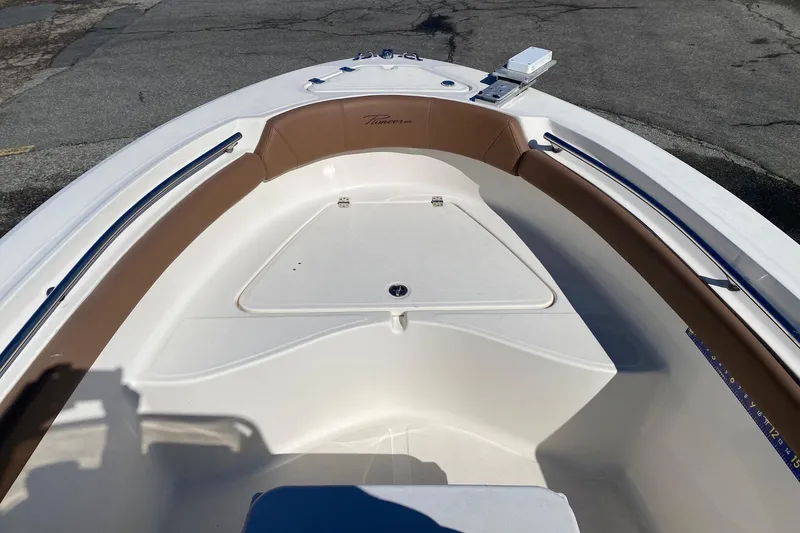 Slide: The Image of 2022 Pioneer 202 Sportfish boat interior with brown seating and storage compartment. - 14