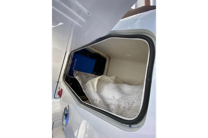 Slide: The Image of Open storage compartment on 2022 Pioneer 202 Sportfish boat, showing interior contents. - 16