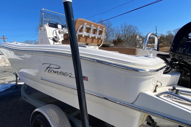 Slide: The Image of 2022 Pioneer 202 Sportfish boat on trailer, white exterior, sunny day. - 3