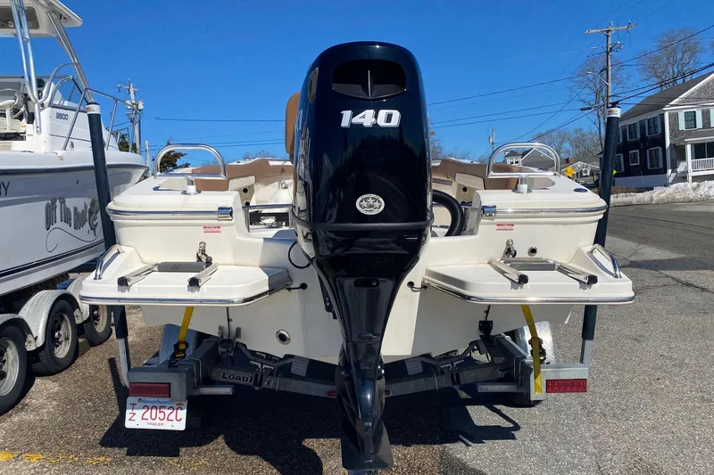 Slide: The Image of 2022 Pioneer 202 Sportfish boat with 140 HP engine, parked on a trailer. - 5