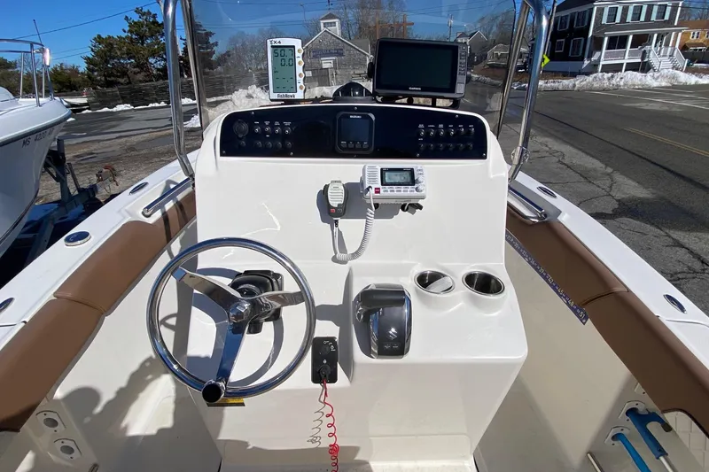 Slide: The Image of 2022 Pioneer 202 Sportfish boat console with steering wheel, controls, and navigation equipment. - 8