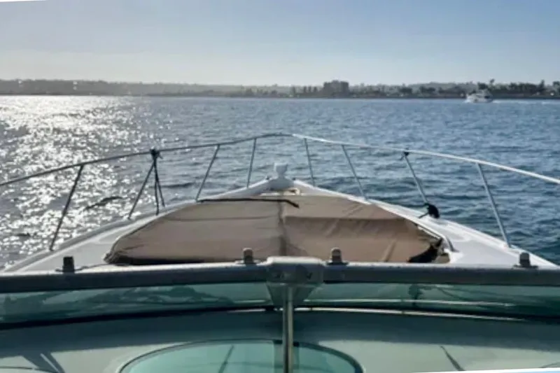 Slide: The Image of Bow view of 2000 Maxum 3700 SCR yacht on sunny ocean waters. - 11