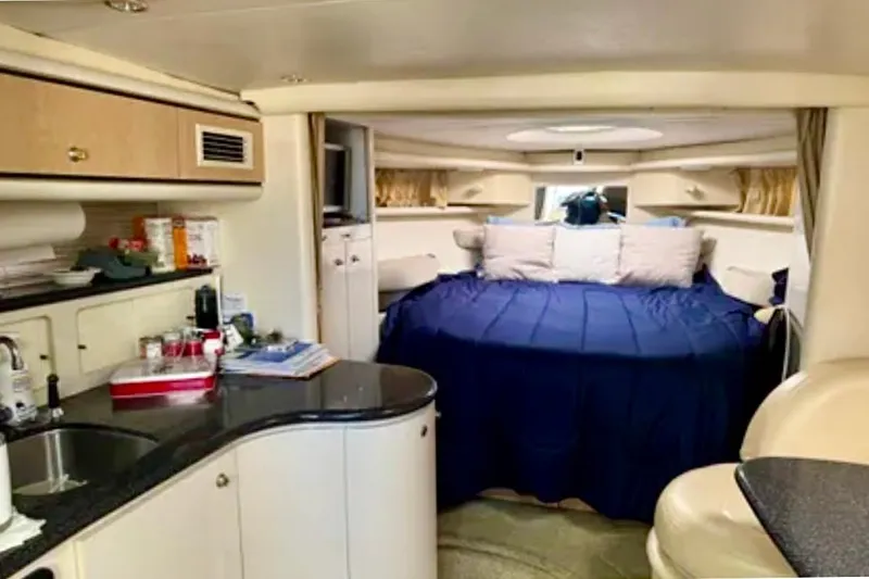 Slide: The Image of Interior of 2000 Maxum 3700 SCR yacht with kitchen, seating, and sleeping area. - 5