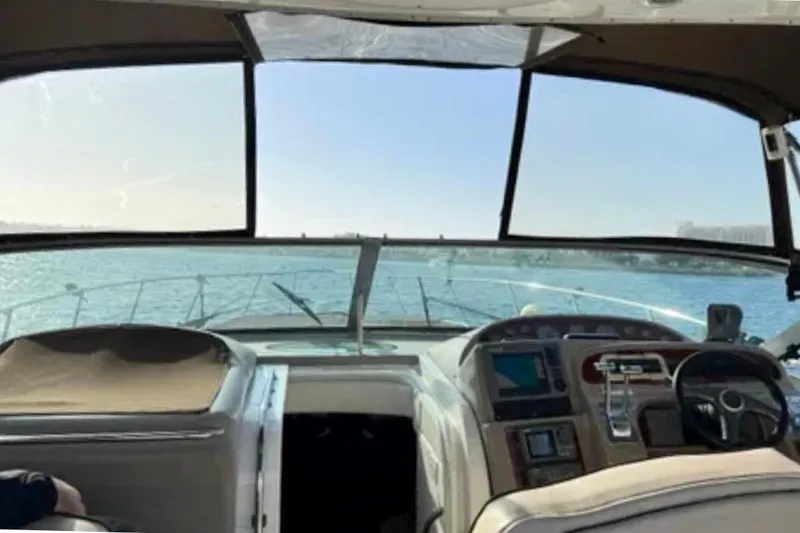 Slide: The Image of Maxum 3700 SCR boat interior with ocean view, city skyline in background, 2000 model. - 9