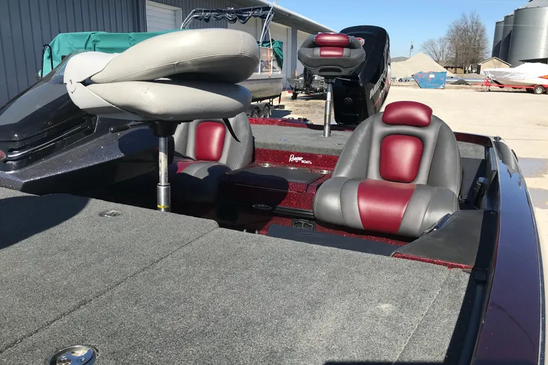 Slide: The Image of 2016 Ranger Z118 Comanche boat interior with red and gray seating. - 16
