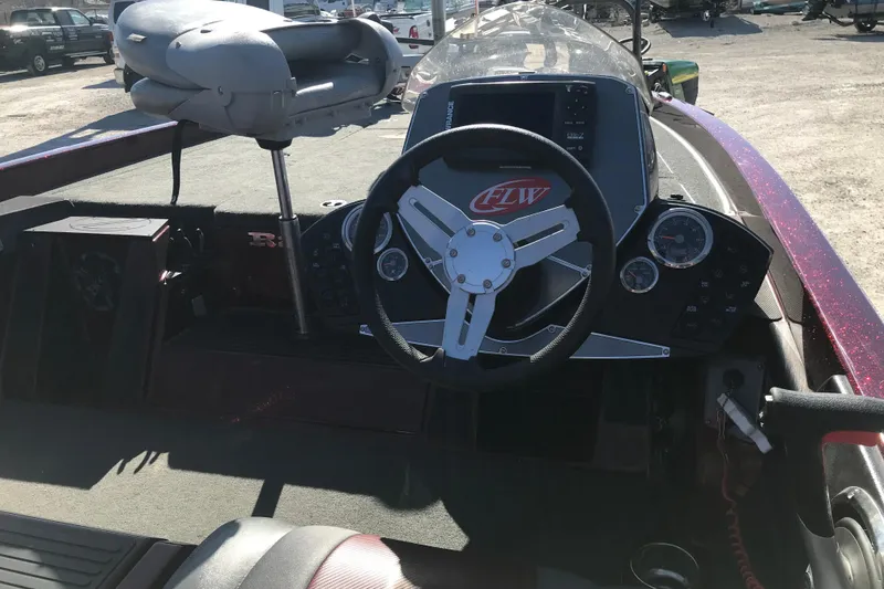 Slide: The Image of 2016 Ranger Z118 Comanche boat cockpit with steering wheel and control panel. - 18