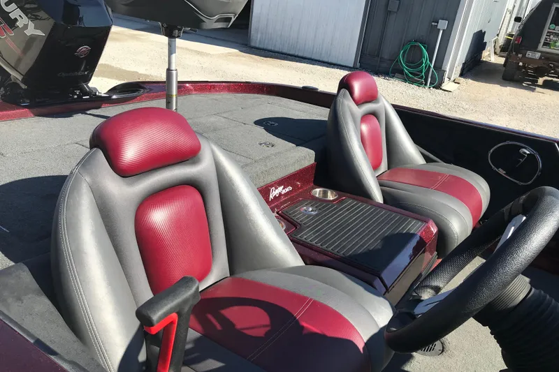 Slide: The Image of 2016 Ranger Z118 Comanche boat interior with red and gray seats, steering wheel, and console. - 20