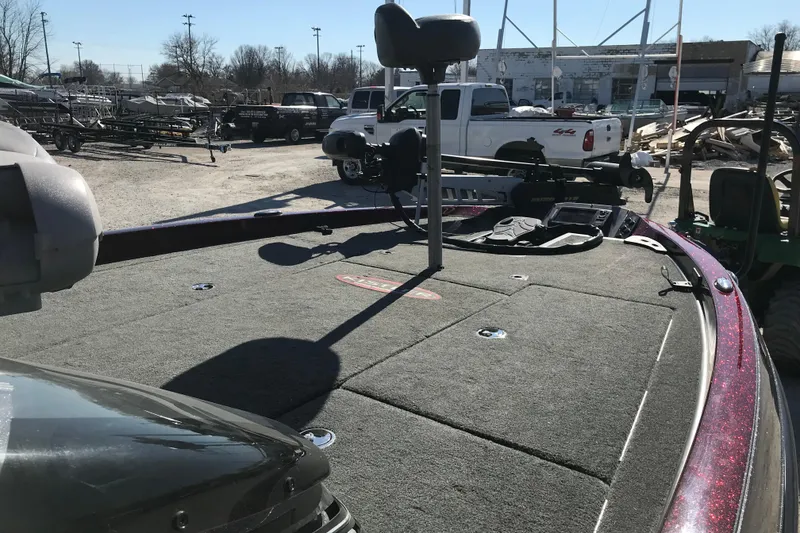 Slide: The Image of 2016 Ranger Z118 Comanche boat deck with fishing seat and equipment in a parking lot. - 21