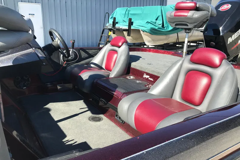 Slide: The Image of 2016 Ranger Z118 Comanche boat interior with red and gray seats, steering wheel, and console. - 25