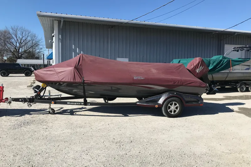 Slide: The Image of 2016 Ranger Z118 Comanche boat covered on trailer, parked outdoors. - 30