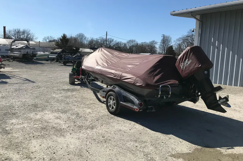 Slide: The Image of 2016 Ranger Z118 Comanche boat covered and parked outdoors on a trailer. - 31