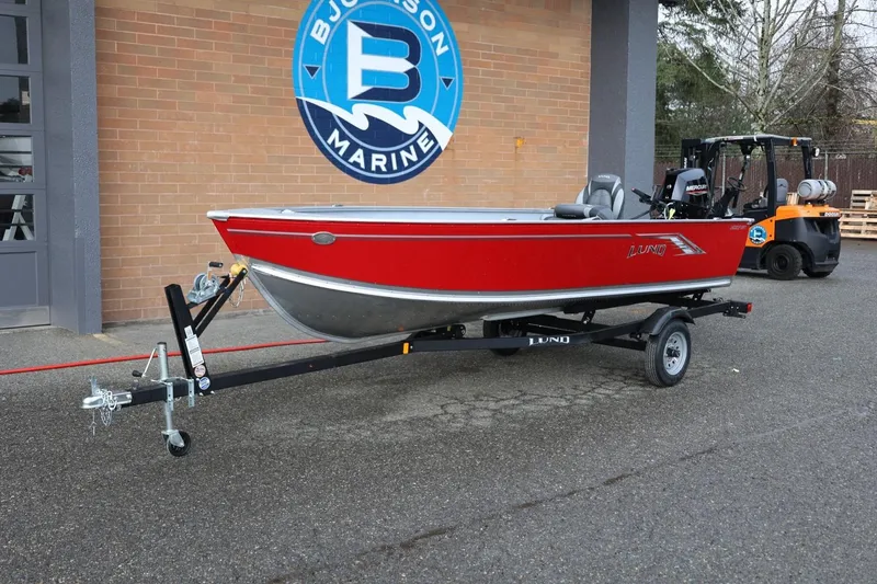 Slide: The Image of 2026 Lund 1600 Fury Tiller boat in red on trailer at dealership. - 15