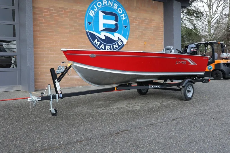 Slide: The Image of 2026 Lund 1600 Fury Tiller boat in red on trailer at Bjornson Marine. - 16