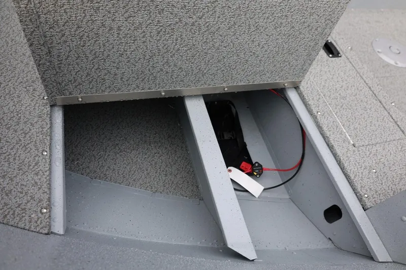 Slide: The Image of 2026 Lund 1600 Fury Tiller boat storage compartment with wiring and battery. - 18