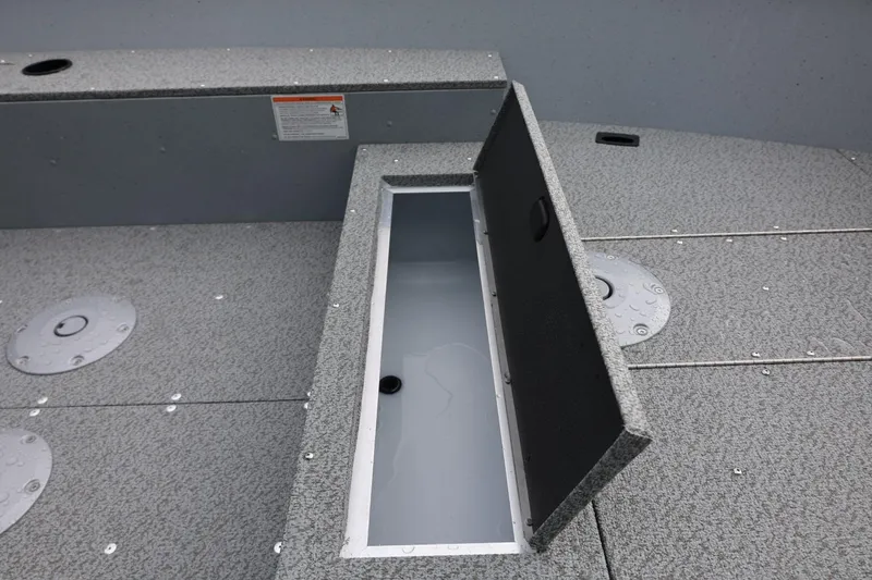 Slide: The Image of 2026 Lund 1600 Fury Tiller boat storage compartment with open lid, showcasing interior space. - 21