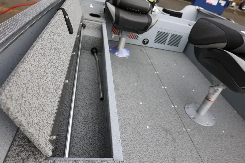 Slide: The Image of 2026 Lund 1600 Fury Tiller boat interior with storage compartment and seating. - 24