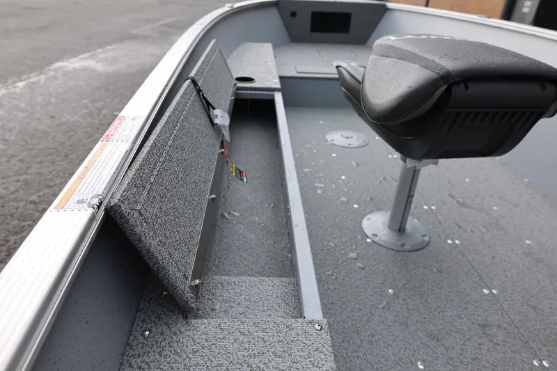 Slide: The Image of 2026 Lund 1600 Fury Tiller boat interior with seat and storage compartments. - 25