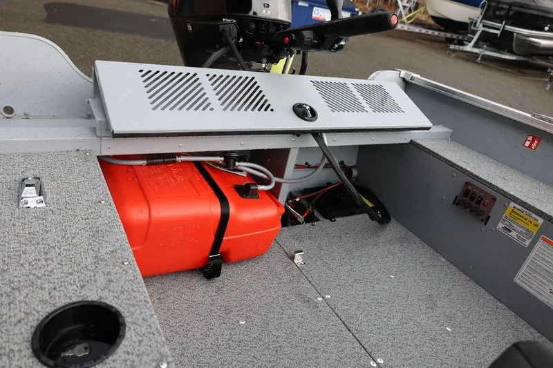 Slide: The Image of 2026 Lund 1600 Fury Tiller boat interior with fuel tank and control panel. - 26