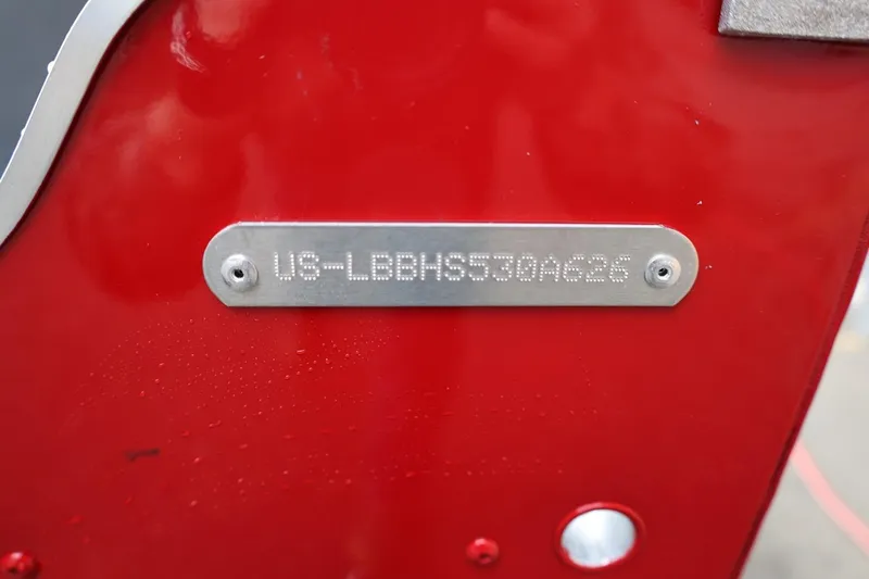 Slide: The Image of Red 2026 Lund 1600 Fury Tiller boat with visible identification plate. - 7