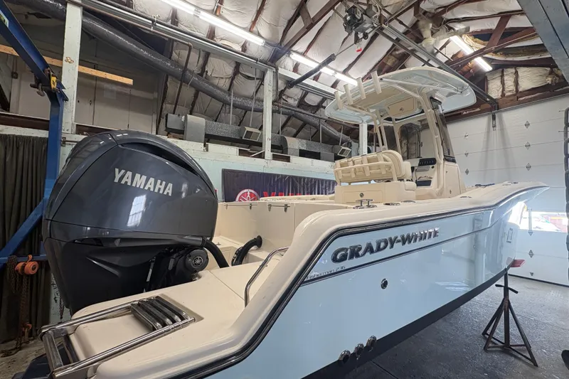 The Image of 2022 Grady-White Fisherman 236 boat with Yamaha engine in a garage setting. - 0