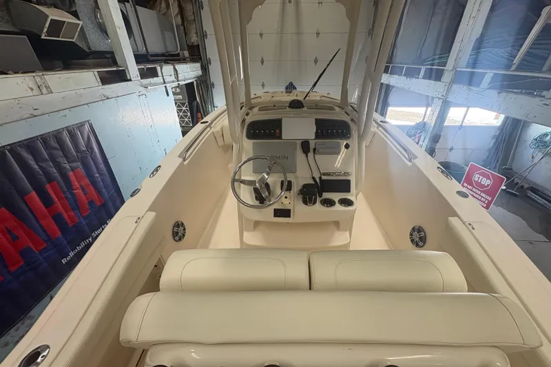 Slide: The Image of 2022 Grady-White Fisherman 236 boat interior with steering console in a garage setting. - 3
