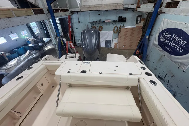 Slide: The Image of 2022 Grady-White Fisherman 236 in a marine service workshop, featuring a spacious deck. - 5