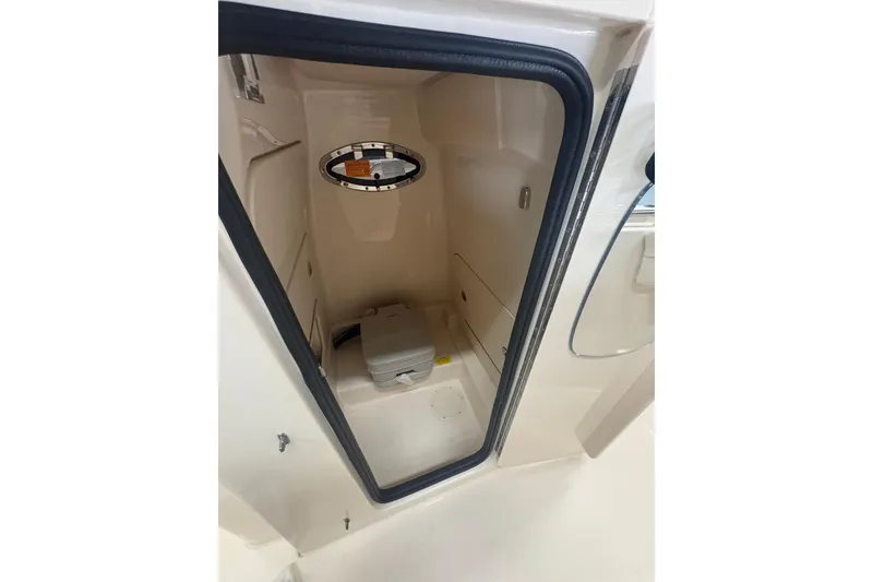 Slide: The Image of 2022 Grady-White Fisherman 236 boat interior storage compartment with portable toilet. - 7