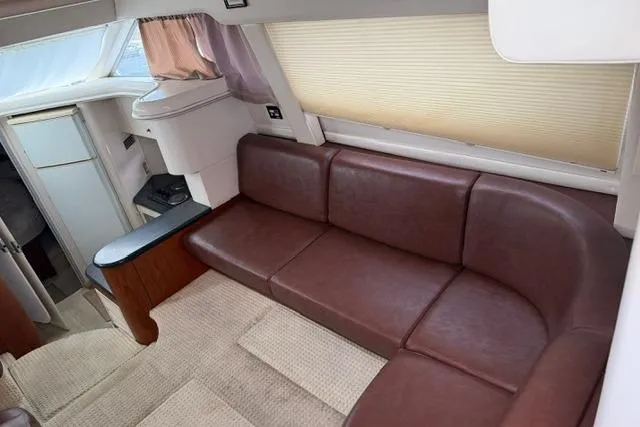 Slide: The Image of Luxurious interior of 2000 Maxum 4100 SCA yacht with brown leather seating. - 22