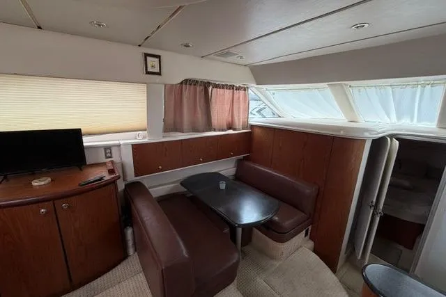 Slide: The Image of Interior of 2000 Maxum 4100 SCA yacht with dining area and TV. - 24