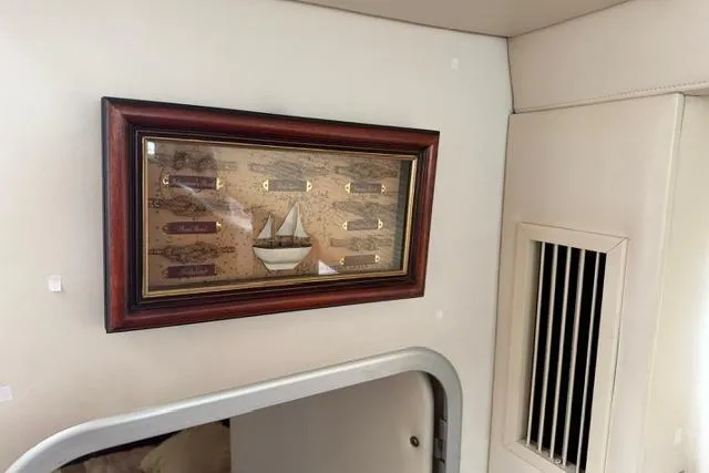Slide: The Image of Framed nautical artwork inside a 2000 Maxum 4100 SCA boat cabin. - 27