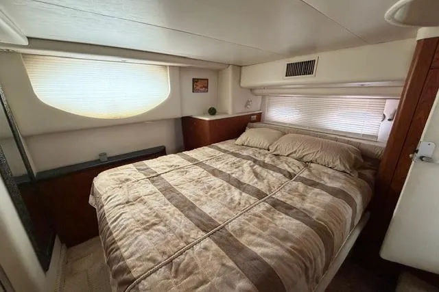 Slide: The Image of Interior cabin of 2000 Maxum 4100 SCA yacht with cozy bed and window blinds. - 32