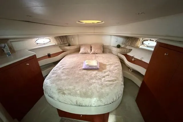 Slide: The Image of Luxurious cabin interior of 2000 Maxum 4100 SCA yacht with cozy bed and elegant wood finish. - 35
