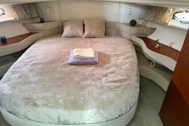 Slide: The Image of Luxurious bedroom interior of 2000 Maxum 4100 SCA yacht with plush bedding. - 36