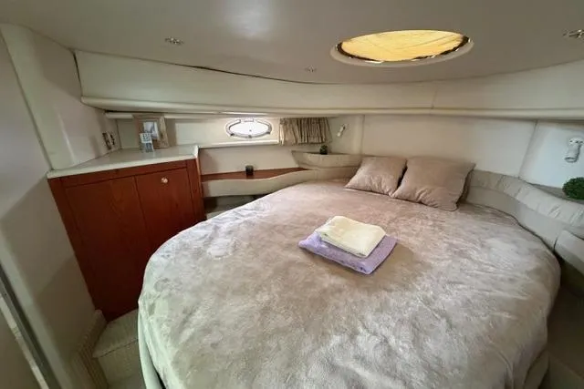 Slide: The Image of Luxurious cabin interior of 2000 Maxum 4100 SCA yacht with cozy bed and wooden cabinetry. - 37