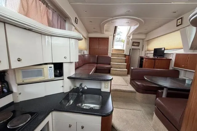 Slide: The Image of Luxurious interior of 2000 Maxum 4100 SCA yacht with modern kitchen and seating area. - 42