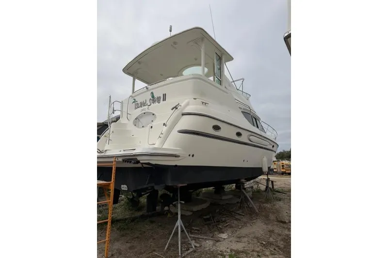 Slide: The Image of 2000 Maxum 4100 SCA yacht on dry dock, side view. - 8