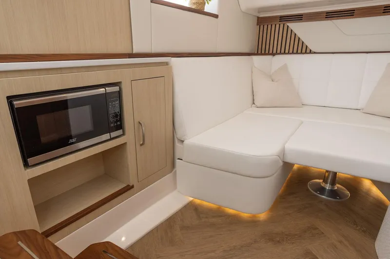 Slide: The Image of Manufacturer Provided Image: Luxurious interior of 2026 Regal LX43 yacht with modern seating and built-in microwave. - 17
