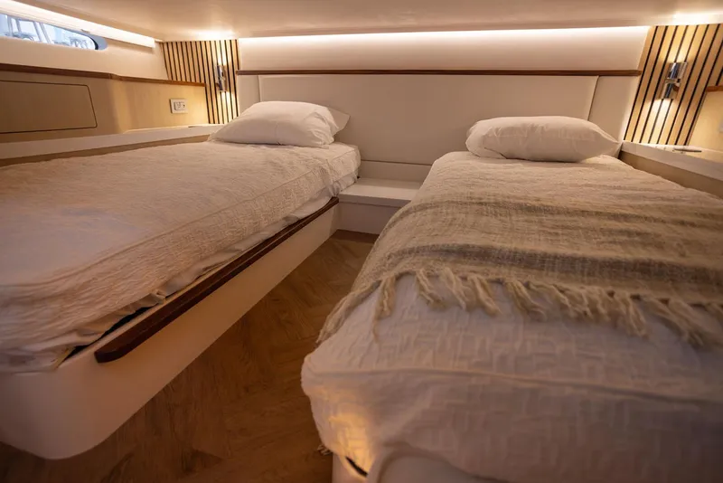 Slide: The Image of Manufacturer Provided Image: Luxurious twin beds in 2026 Regal LX43 yacht cabin, featuring modern design and cozy lighting. - 18