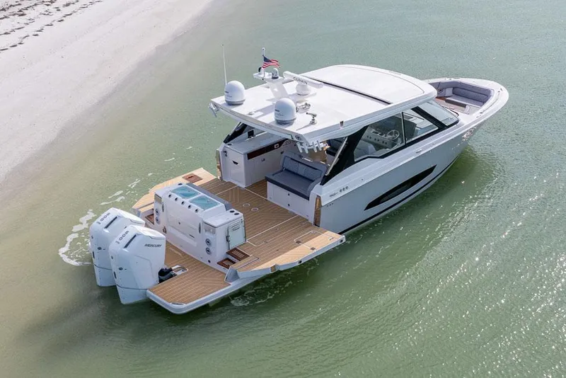 Slide: The Image of Manufacturer Provided Image: 2026 Regal LX43 luxury boat on calm water near sandy beach. - 3