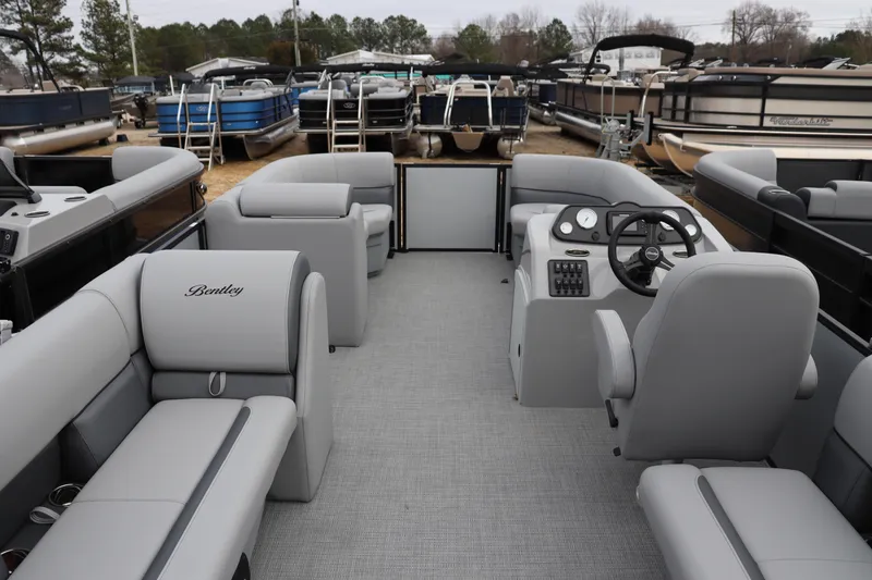 Slide: The Image of 2026 Bentley Pontoons LE 200 CW interior with gray seating and steering console. - 8