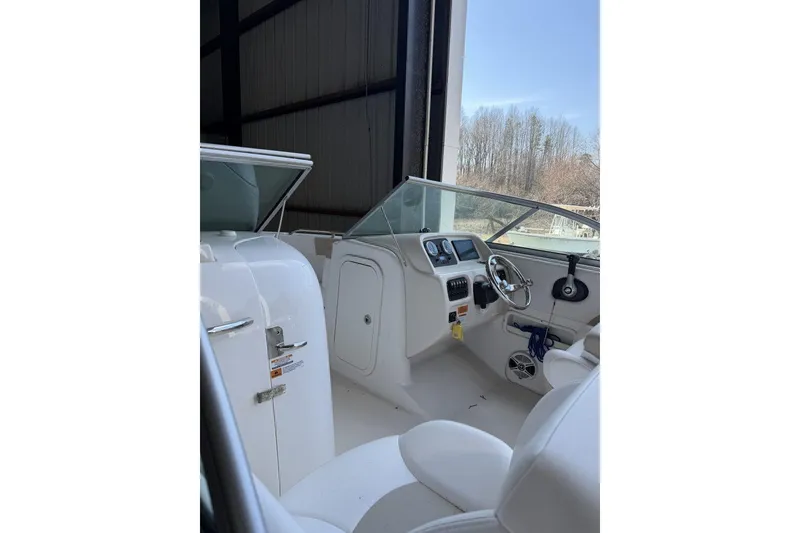 Slide: The Image of 2020 Robalo R227 Dual Console boat interior with steering wheel and seating. - 2