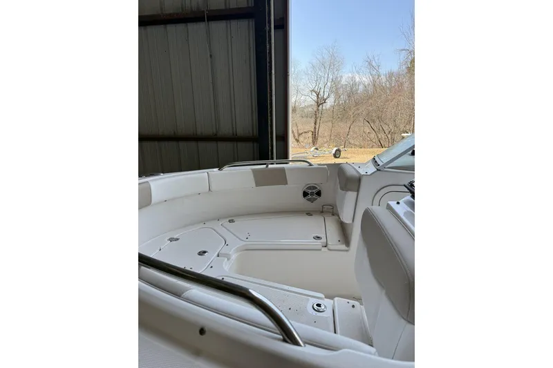 Slide: The Image of 2020 Robalo R227 Dual Console boat interior in storage, showing seating and console. - 3