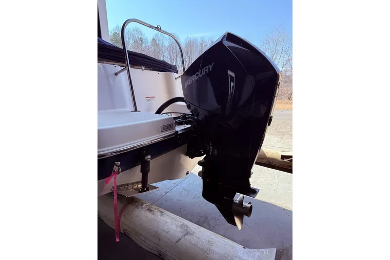 Slide: The Image of 2020 Robalo R227 Dual Console with Mercury outboard engine, docked outdoors. - 4