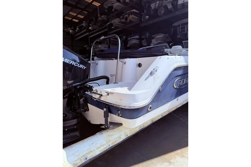 Slide: The Image of 2020 Robalo R227 Dual Console boat with Mercury engine in storage. - 5